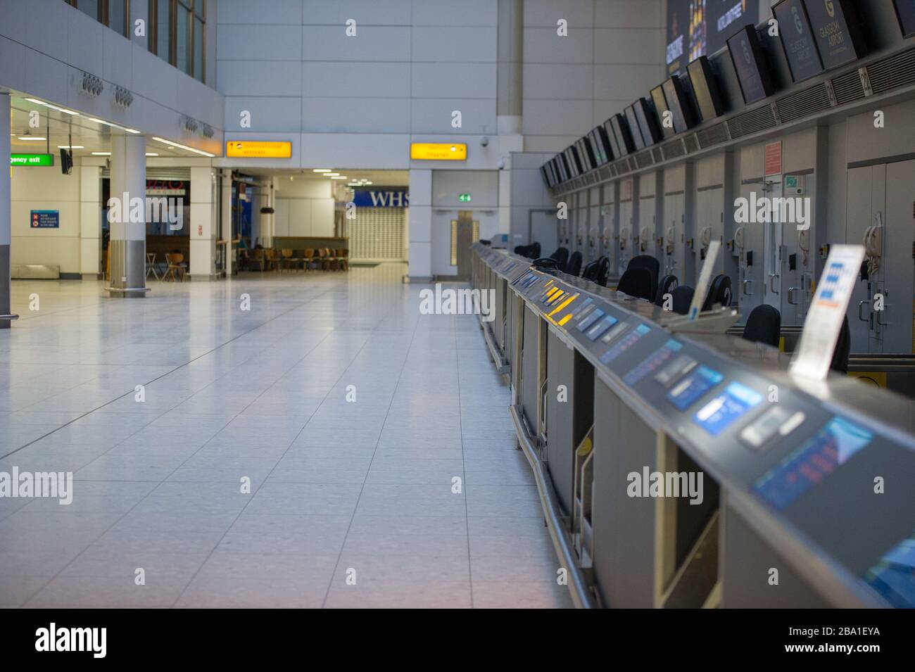 Glasgow, UK. 25th Mar, 2020. Pictured: Views the interior of Glasgow Airport passenger terminal showing the place deserted due to airlines suspending and cancelling flights due to the coronavirus pandemic. Credit: Colin Fisher/Alamy Live News Stock Photo