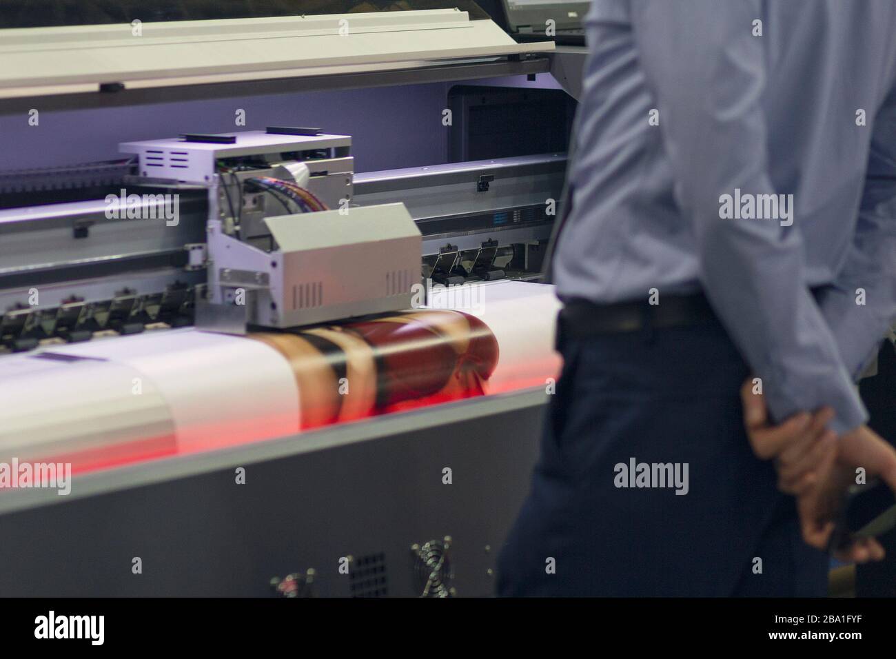 Large-format printing machine in the printing house. Industry Stock Photo