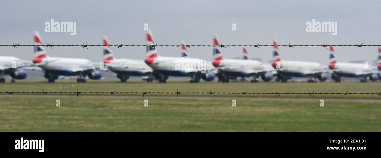 Glasgow, UK. 25th Mar, 2020. Pictured: British Airways Airbus Aircraft stand grounded on the tarmac at Glasgow Airport. The group of Airbus Aircraft comprise of Airbus A321, A320 and one A319 aircraft. Credit: Colin Fisher/Alamy Live News Stock Photo