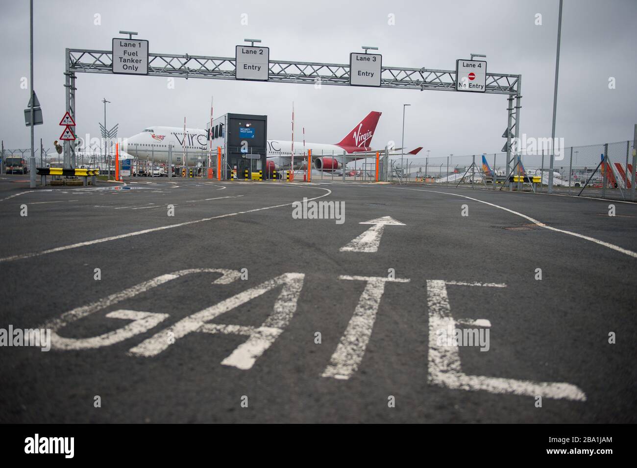 Glasgow, UK. 25th Mar, 2020. Pictured: Virgin Atlantic aircraft (Boeing 747-400 series - named Ruby Tuesday, registered G-VXLG) and an Airbus A330-200 - named Honkytonk Woman, registered G-VMIK) stand grounded on the tarmac by the Logan Air hanger. Credit: Colin Fisher/Alamy Live News Stock Photo