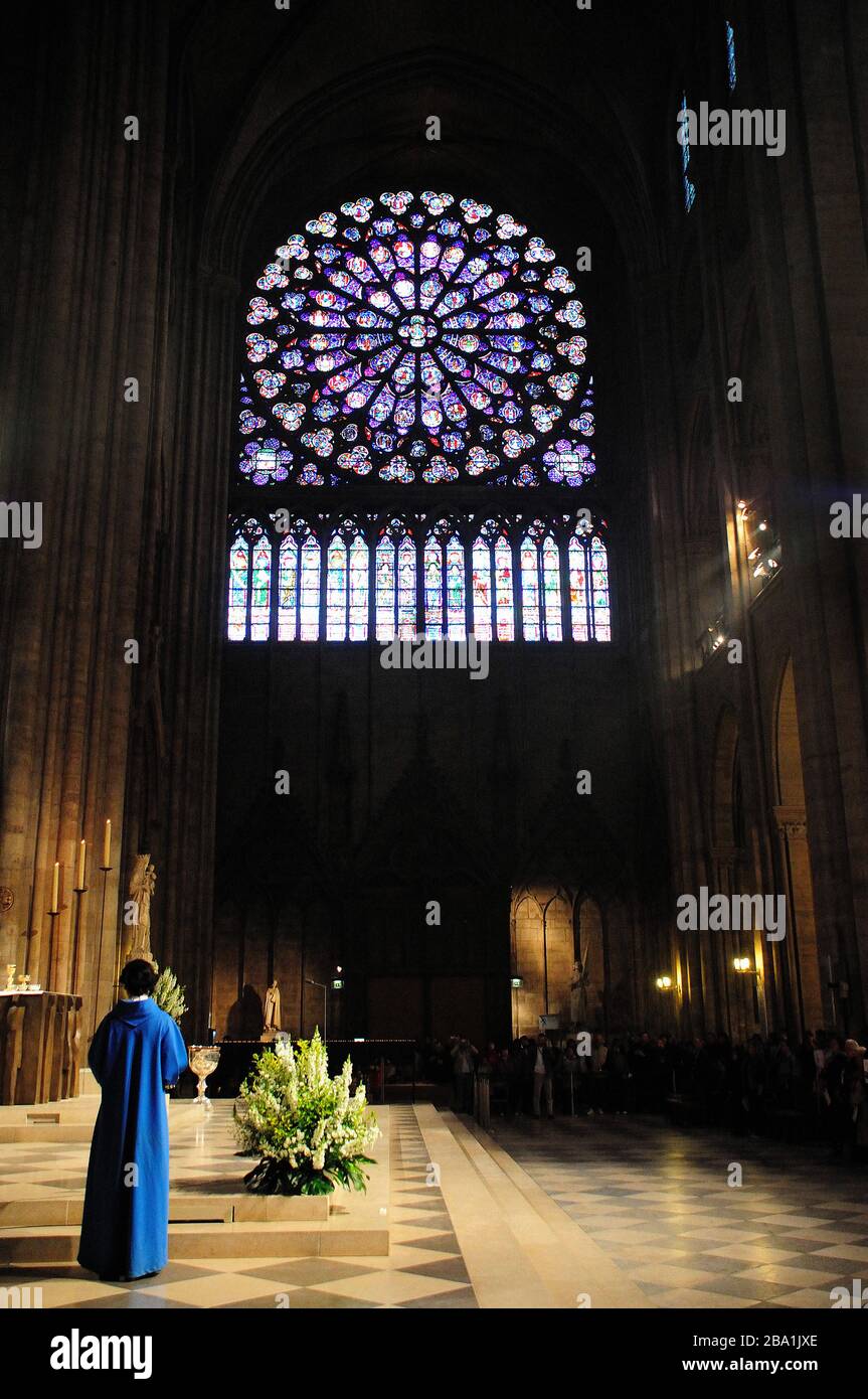 Rear View of Priest in Notre Dame Cathedral, Paris, France Stock Photo