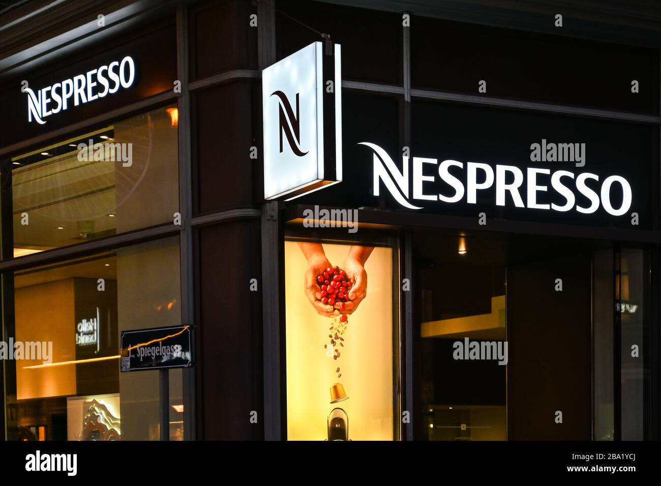 VIENNA, AUSTRIA - NOVEMBER 2019: Illuminated sign on the outside of a branch of Nespresso at night in Vienna city centre Stock Photo