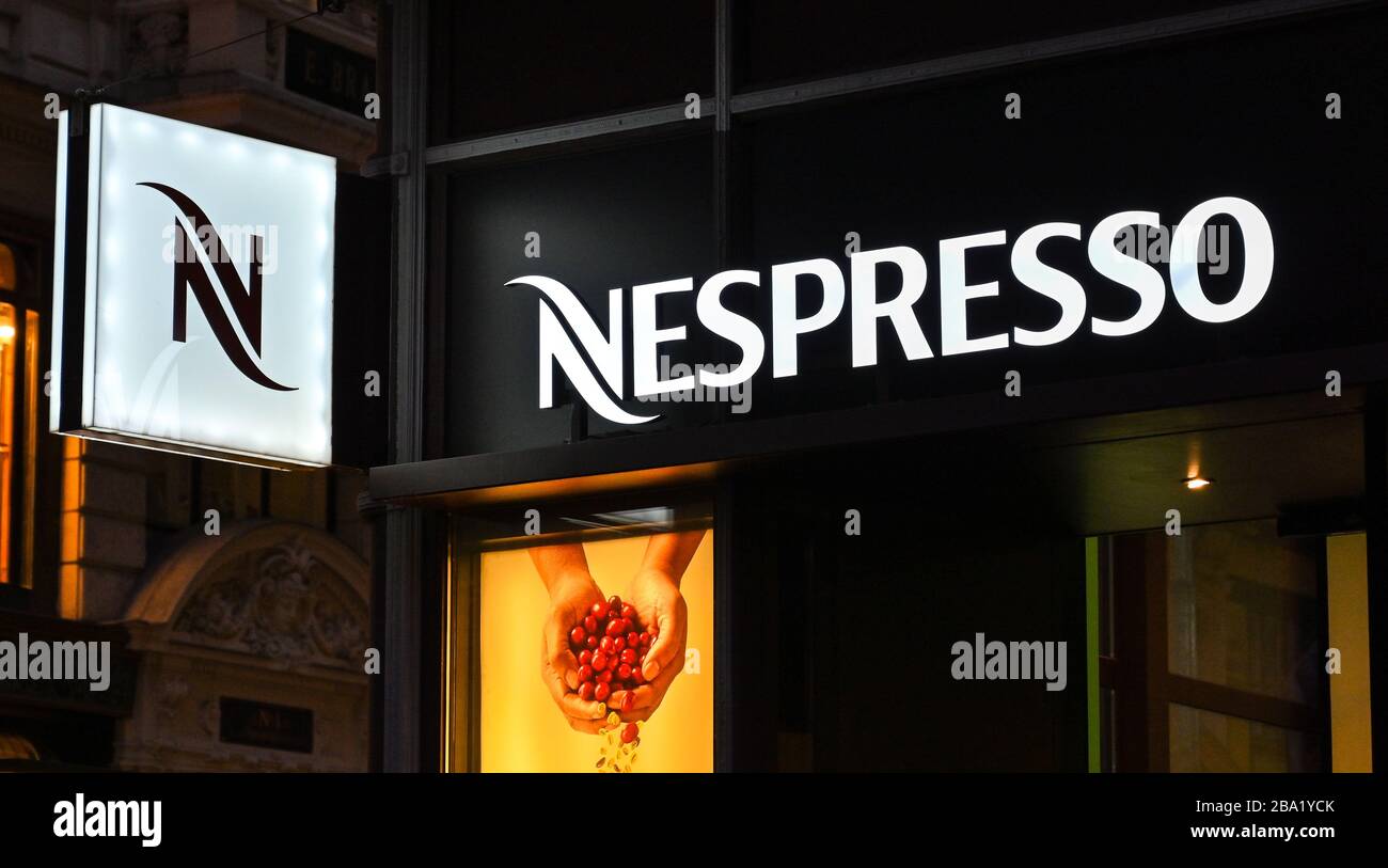 VIENNA, AUSTRIA - NOVEMBER 2019: Illuminated sign on the outside of a branch of Nespresso at night in Vienna city centre Stock Photo