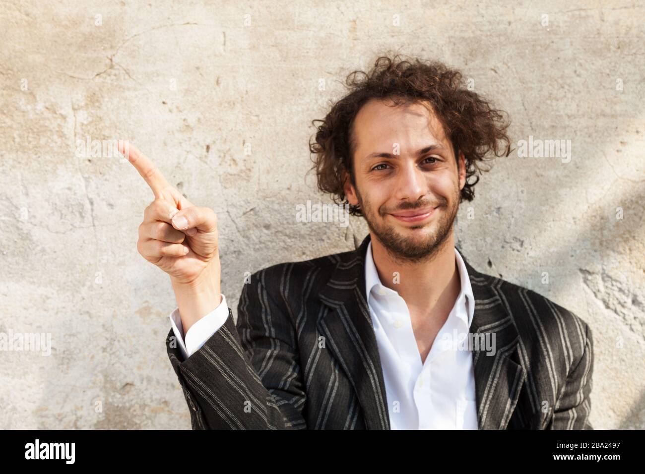 portrait of cheerful young man, wall background Stock Photo