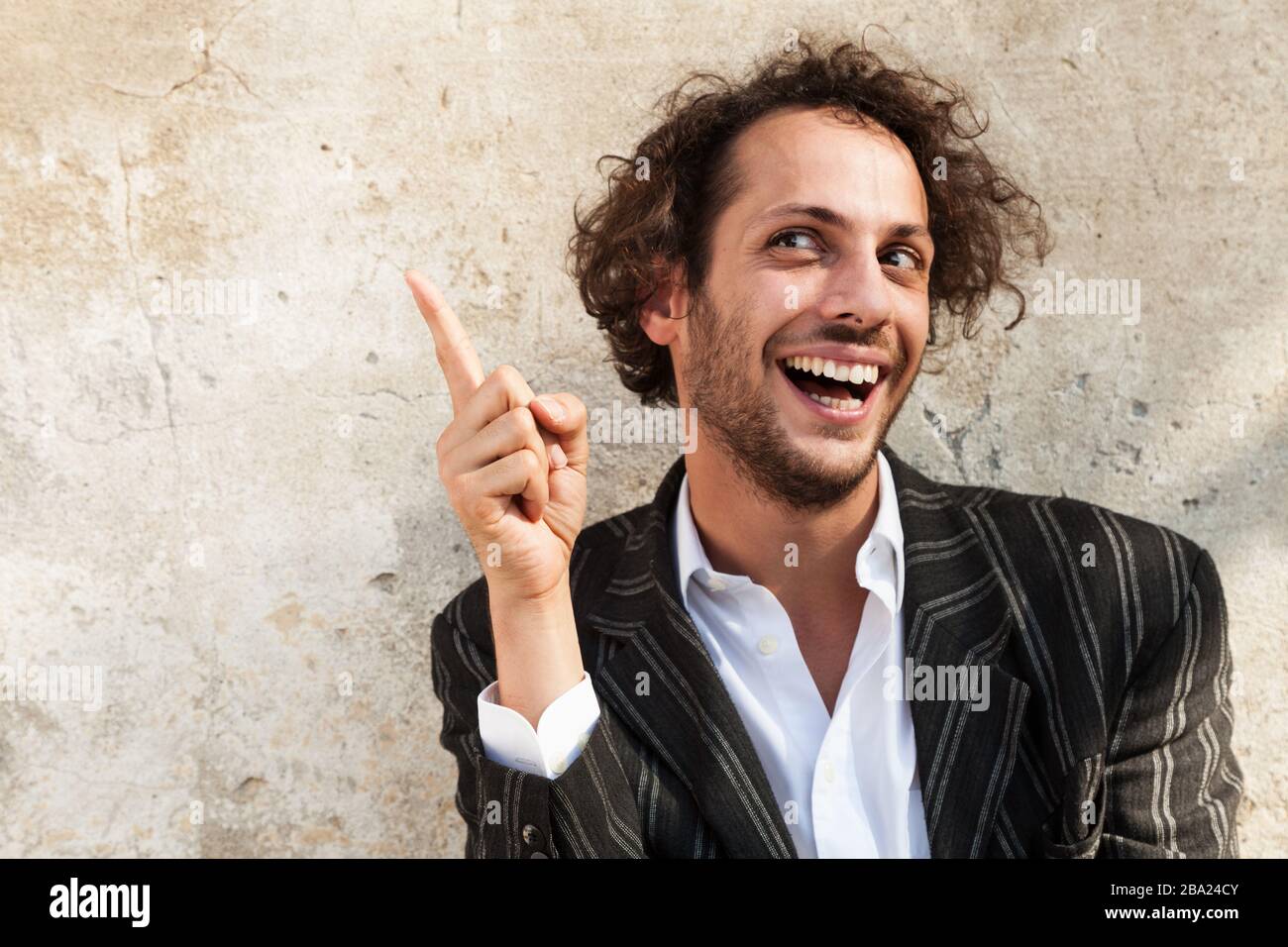 portrait of cheerful young man, wall background Stock Photo