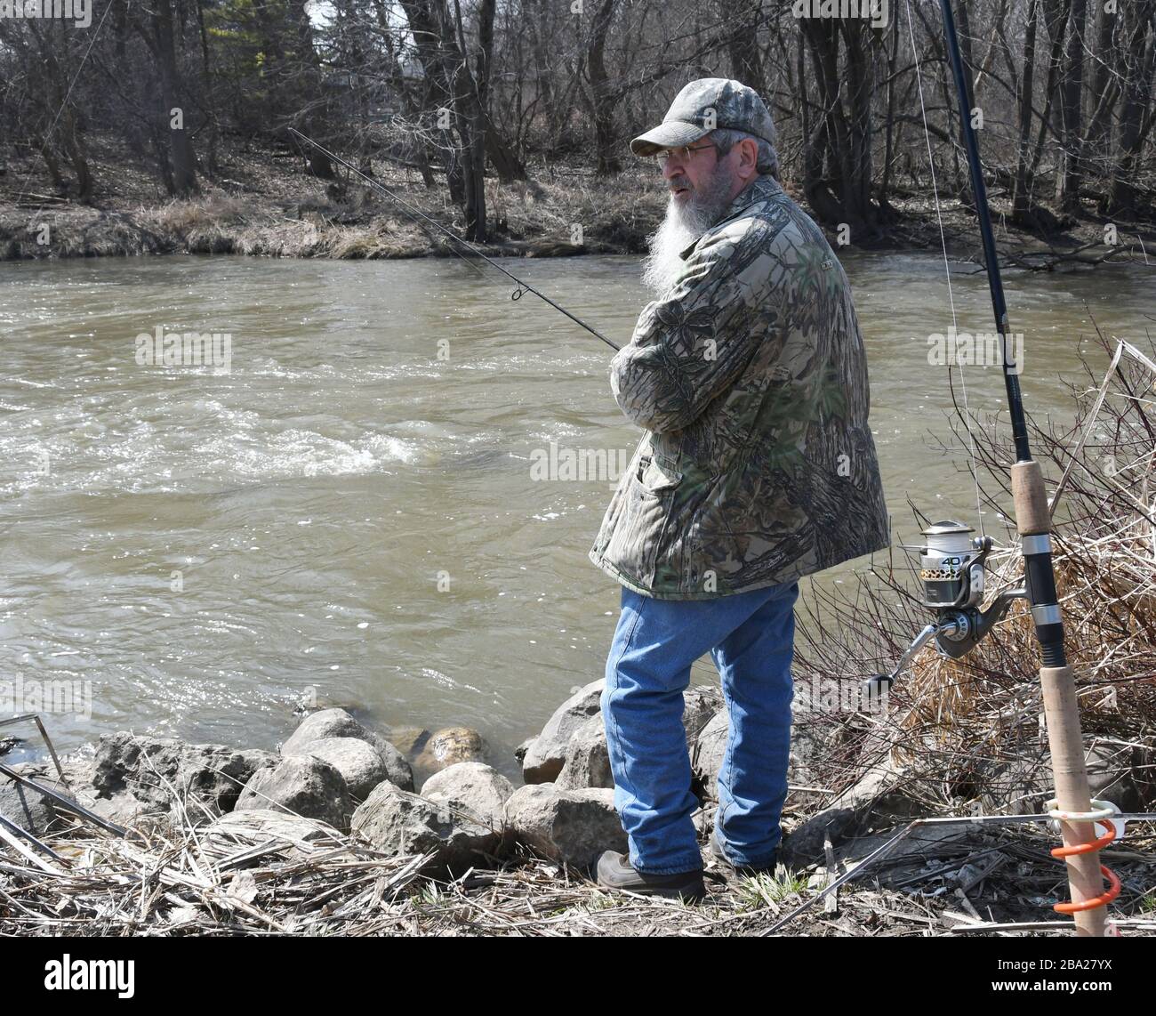 Racine, Wisconsin, USA. 25th Mar, 2020. MIKE DECKER from nearby Sturtevant,  Wisconsin tries his luck fishing in the Root River in Racine, Wisconsin,  and Wednesday March 25, 2020. He alternated between casting