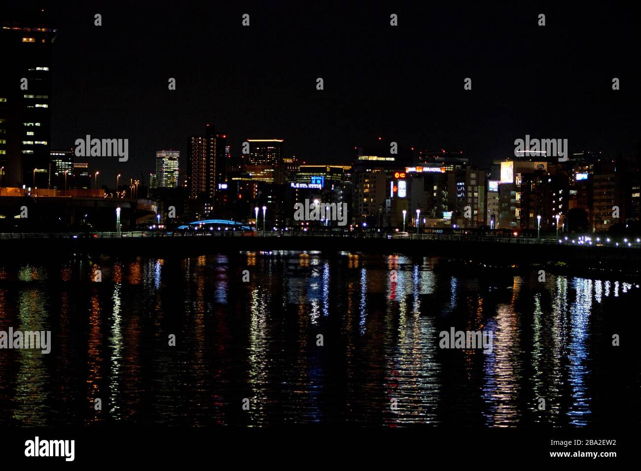 city buildings reflecting on the water at night Stock Photo - Alamy