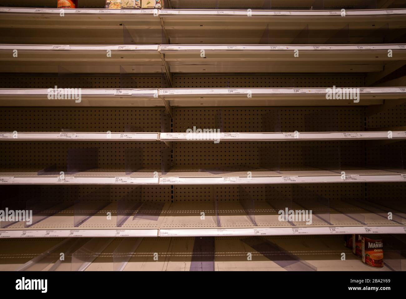 View of empty shelves due to hoarding and broken supply chains during the pandemic. Stock Photo