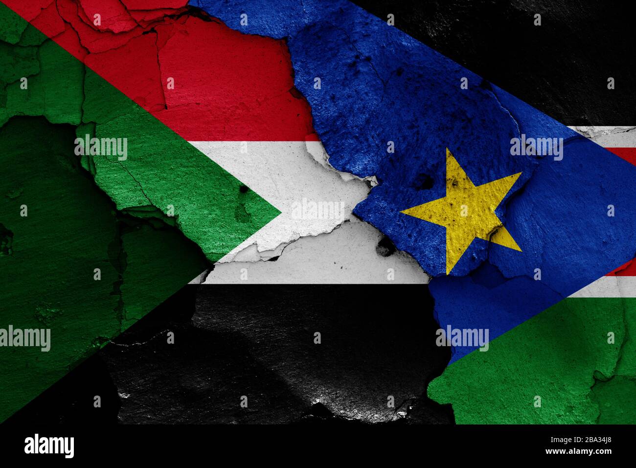 flags of Sudan and South Sudan painted on cracked wall Stock Photo