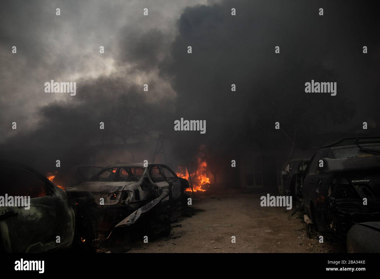 Tripoli, Libya. 25th Mar, 2020. Flames from burning cars are seen at a giant salvage yard which was attacked by Libyan National Army forces in Bou-Selim area, southern Tripoli, Libya, on March 25, 2020. Libya's east-based army said on Wednesday that the army has repelled an attack by the forces of the rival UN-backed government on Alwatya air base, some 130 km southwest of the capital Tripoli. Credit: Amru Salahuddien/Xinhua/Alamy Live News Stock Photo