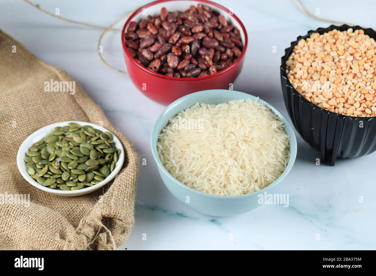 Red beans, rice and peas in colorful bowles on a piece of marble Stock