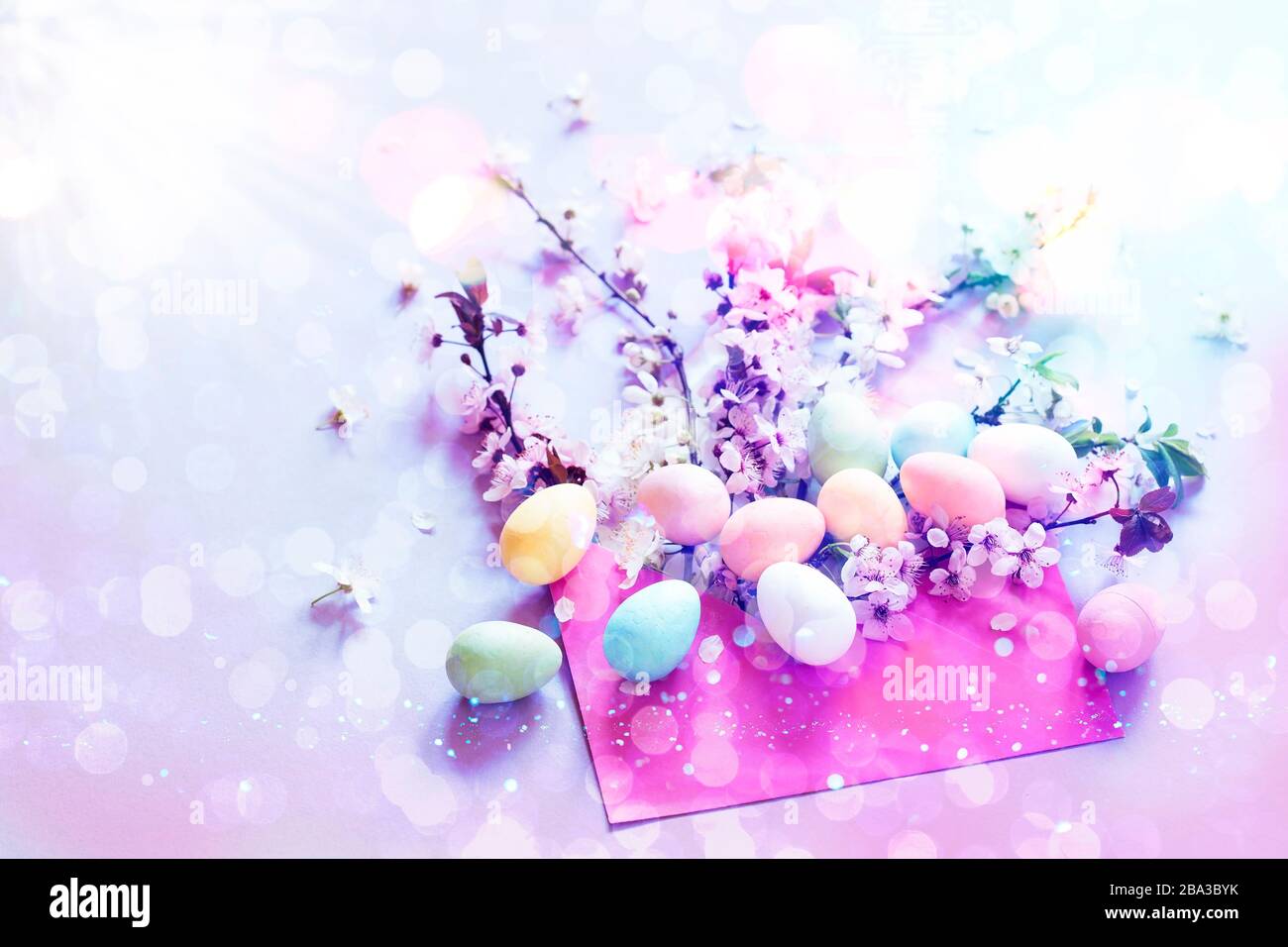 Easter eggs with cherry blossom and a pink envelope Stock Photo