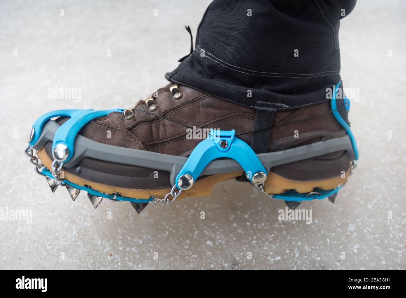 Wearing crampons and gaiters for winter hiking. Stock Photo