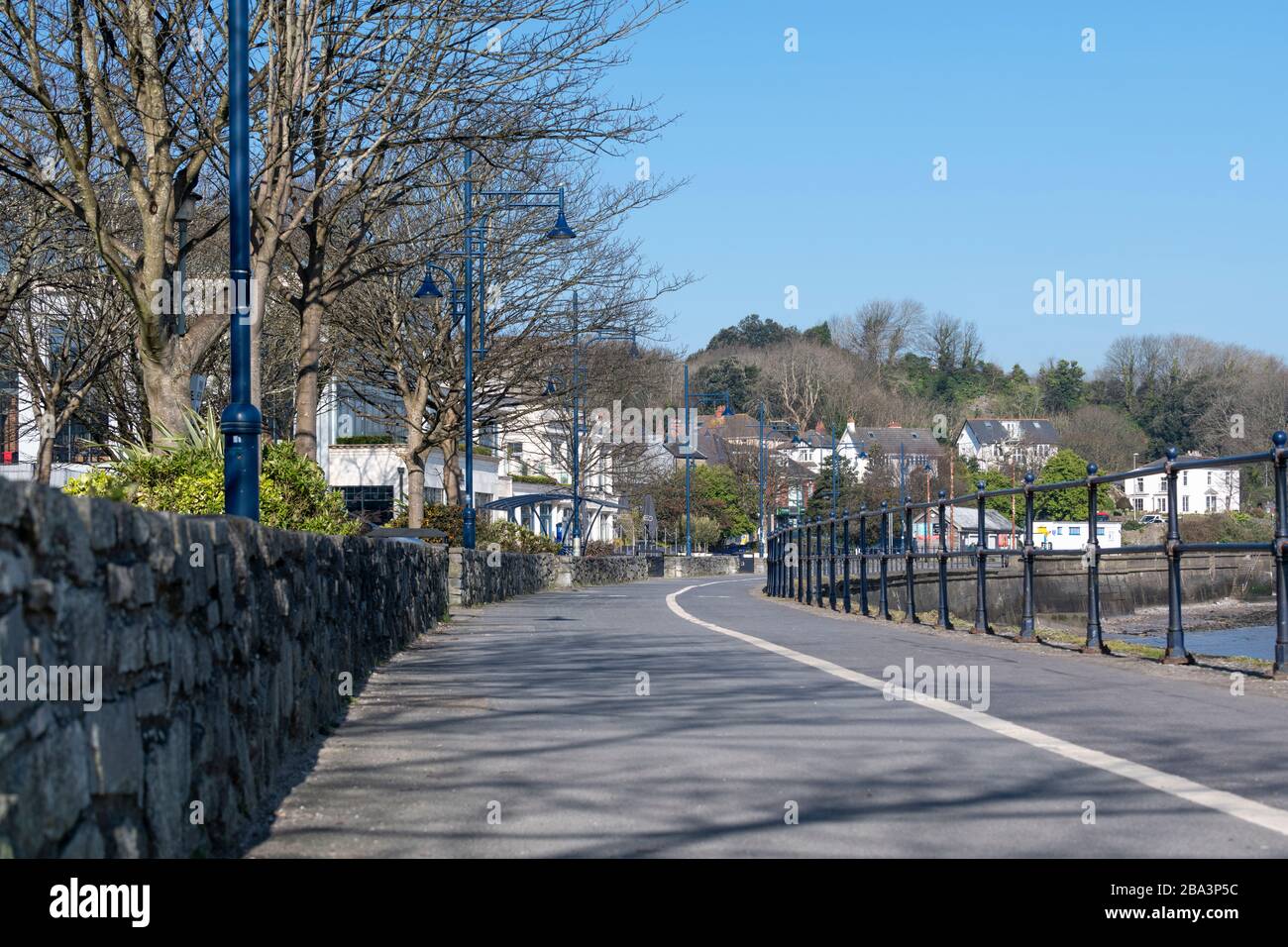 The broad promenade at Mumbles in Swansea Bay. These empty usually-busy streets are a result of Government lockdown for Covid-19 pandemic; people are Stock Photo