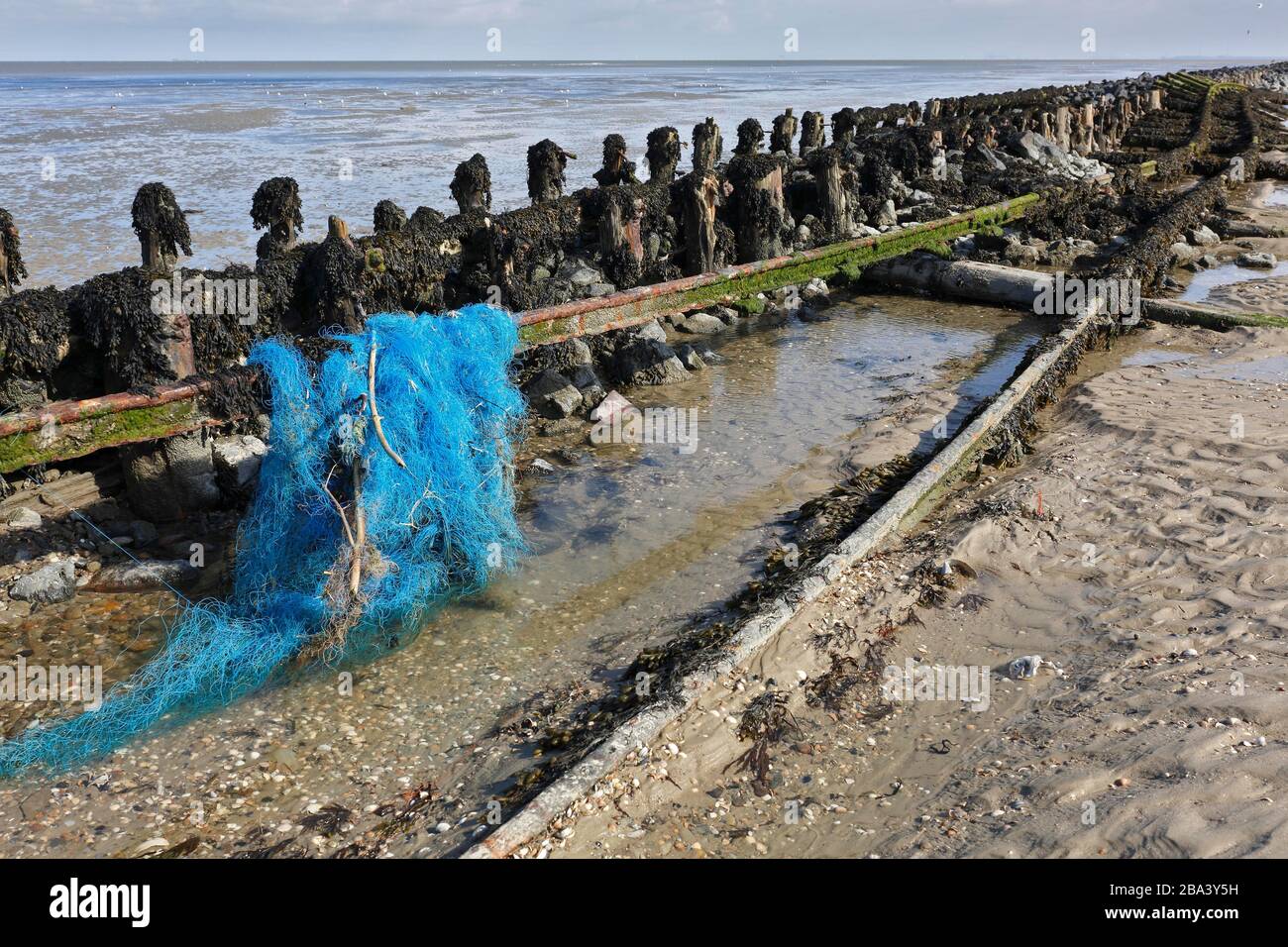 Ailing track systems on the Minsener Oog power station with residual grid, marine waste, Lower Saxony Wadden Sea National Park, Lower Saxony, Germany Stock Photo