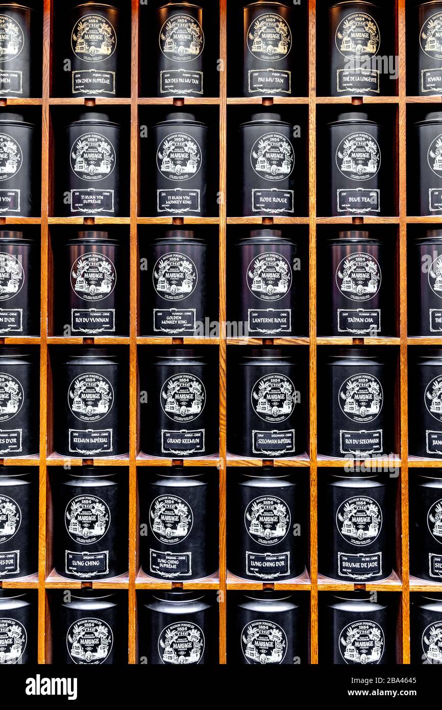 Large tea canisters on shelves at French tea shop Mariage Frères Tea