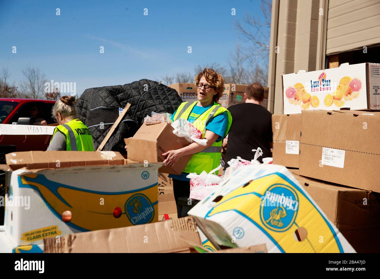 A volunteer at Pantry 279, located at Trinity Lutheran Church, carries
