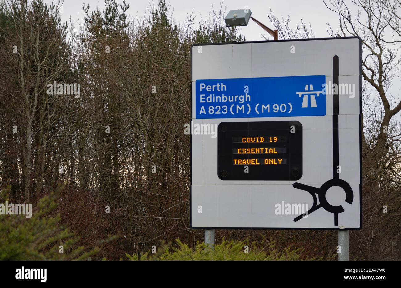 Covid-19 travel restrictions information on motorway sign in Scotland Stock Photo