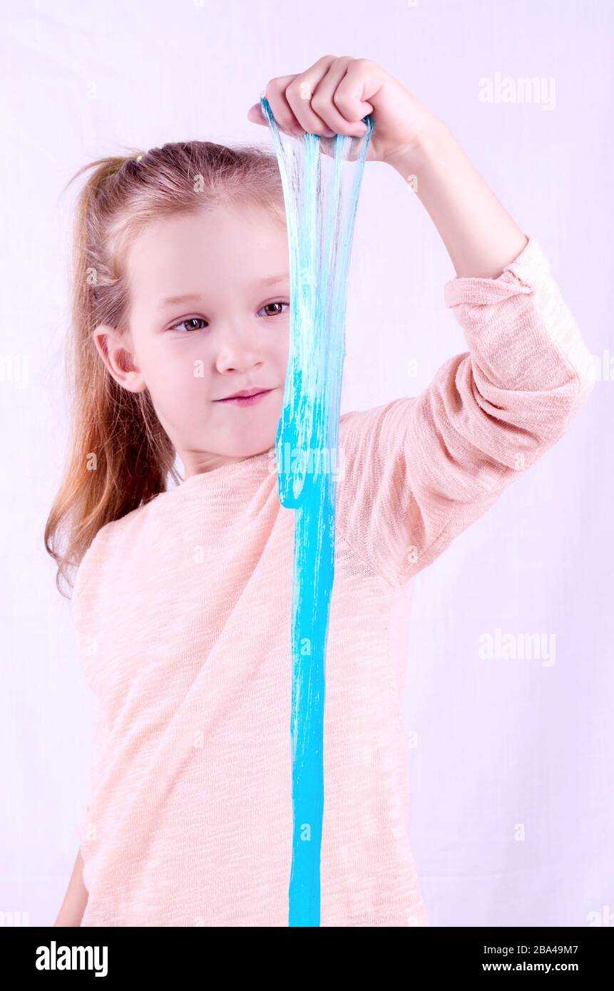a-little-girl-hands-making-slime-herself-on-blue-wooden-background-slime- making-hand-children-toy_t20_rRaG0g - The Breakie Bunch Learning Center