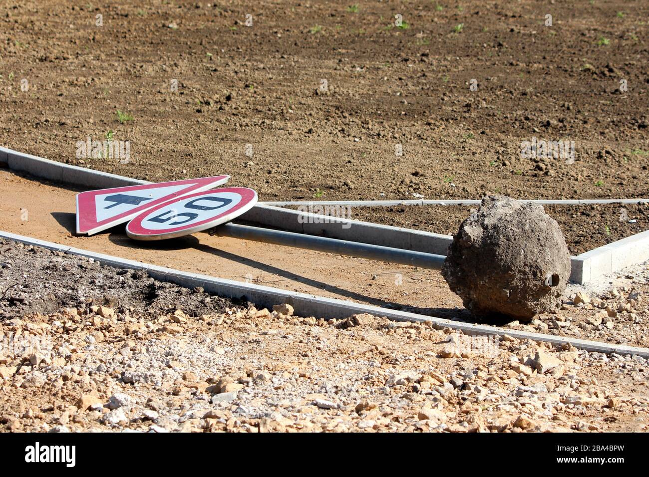 Knocked over old road sign for 50 speed limit and triangle traffic