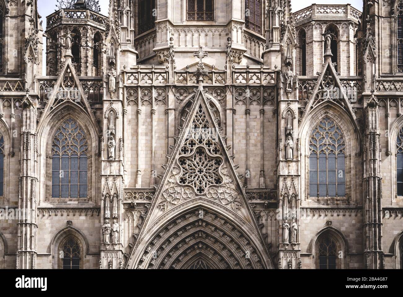 Rose window and sculpted filigrees at the front of a gothic cathedral Stock Photo