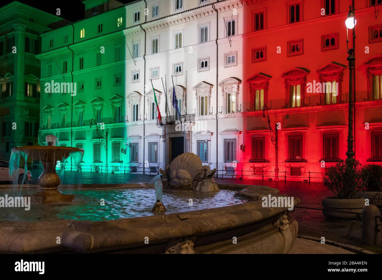 Rome, Italy - March 24, 2020: Palazzo Chigi, seat of the Italian government, facade of the building illuminated with the colors of the Italian flag. Coronavirus emergency Italy. Stock Photo