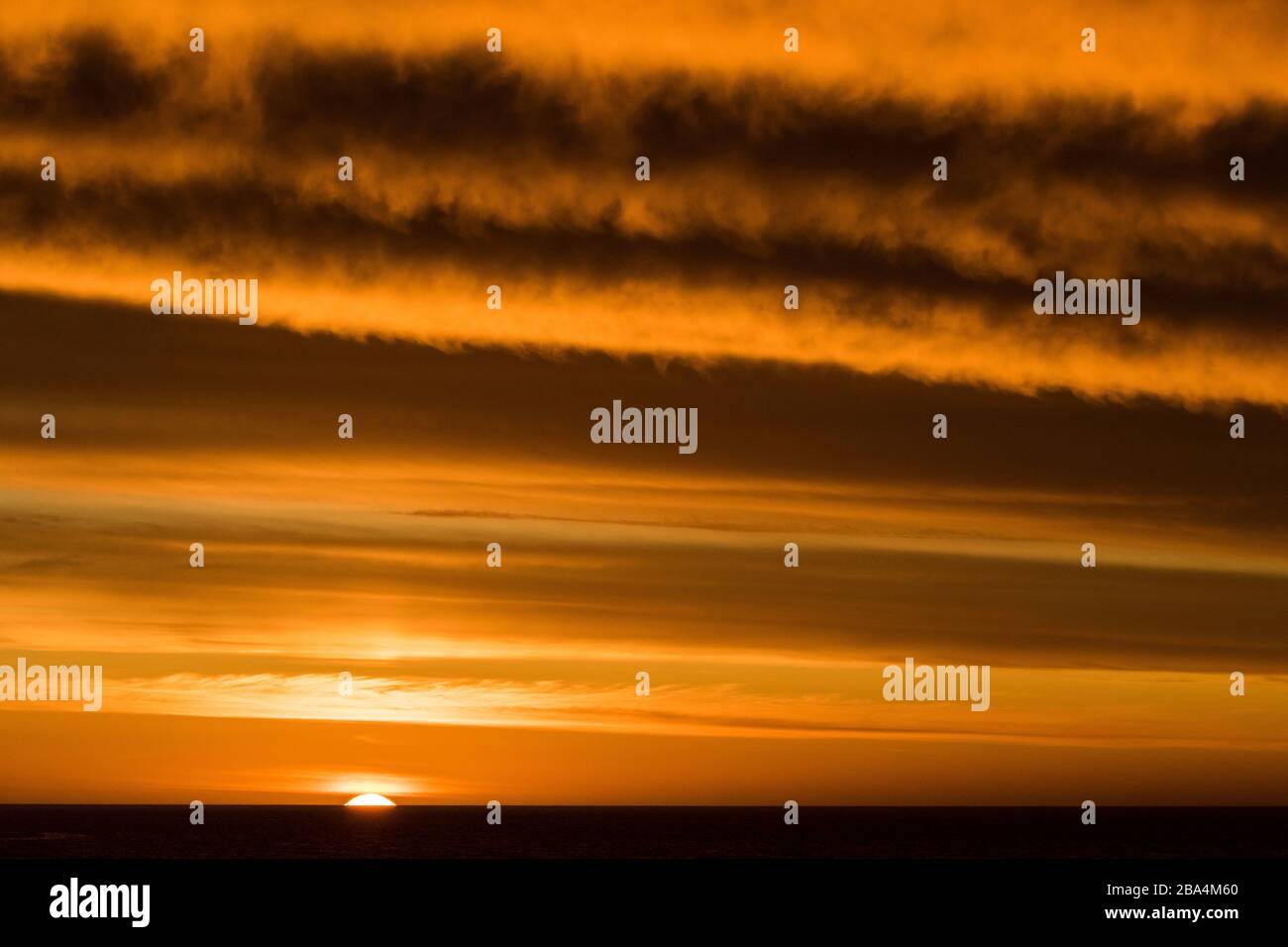 Sun setting over Atlantic Ocean Stock Photo