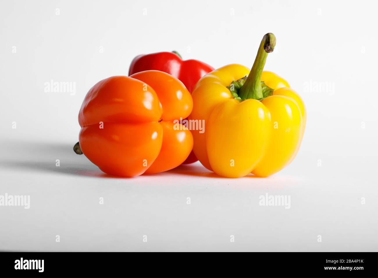 Colorful bell peppers isolated on white background Stock Photo - Alamy