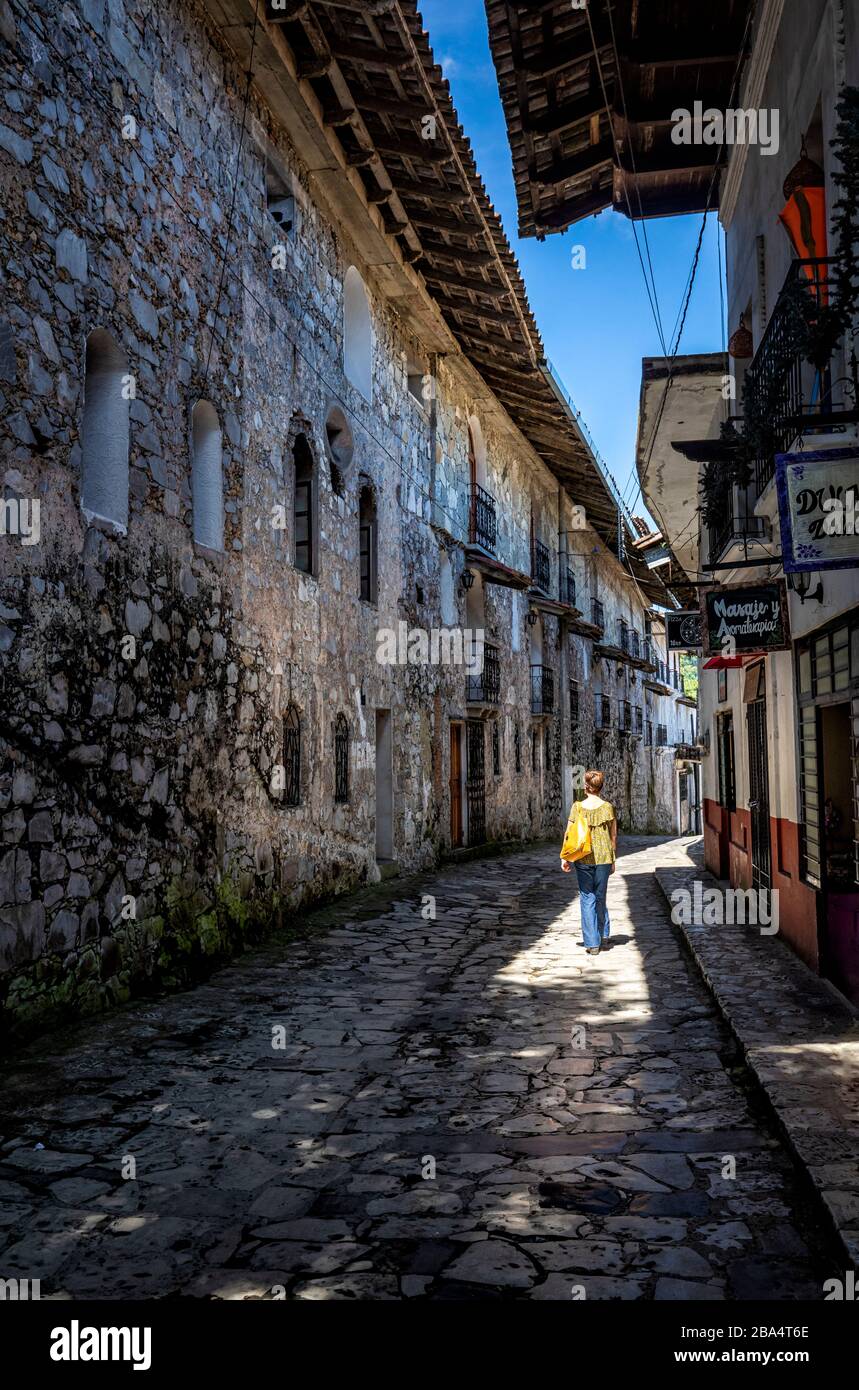 Female tourist walking the narrow streets of Cuetzalan, Puebla, Mexico. Stock Photo