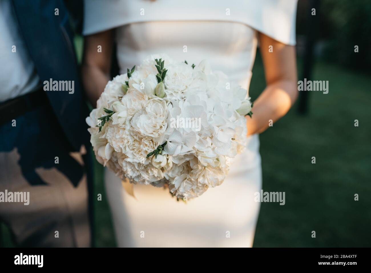 The bride in a beautiful wedding dress and her bridal bouquet of ...