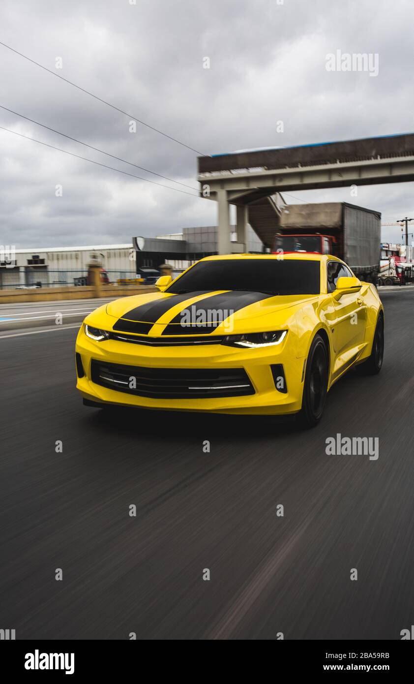Yellow sport car with black stripes on it Stock Photo