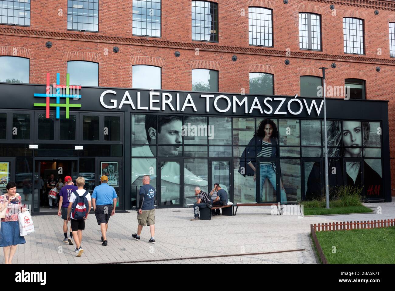 Group Entering Galeria Tomaszow Mall With People Sitting Outside Tomaszow Mazowiecki Central Poland Stock Photo Alamy