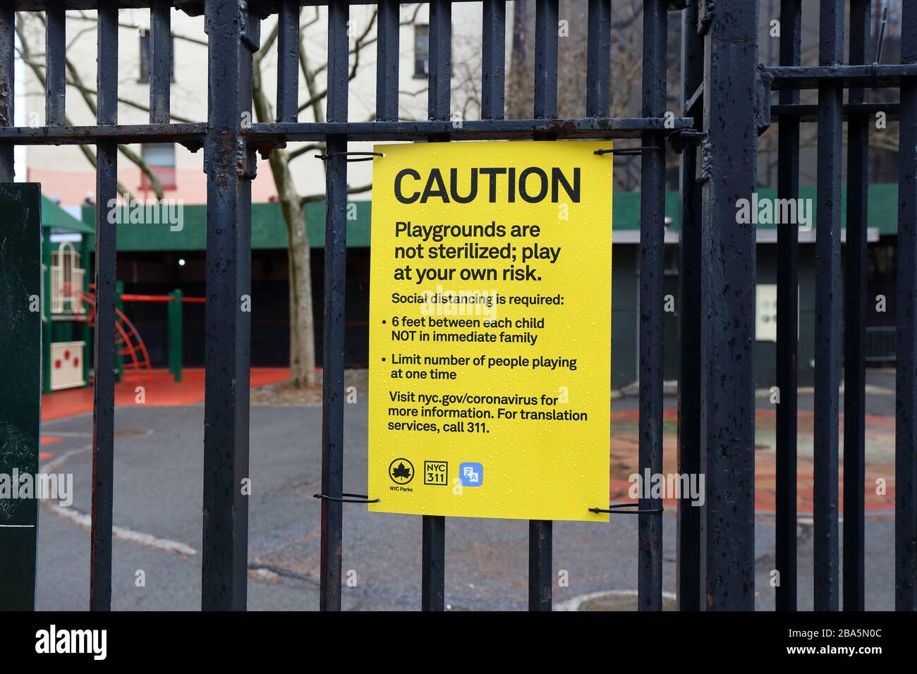 New York, NY, 25th March 2020. A NYC Parks sign at a playground warning visitors to play at their own risk as equipment has not been sterilized or sanitized; and to practice social distancing to prevent the spread of coronavirus COVID-19 pandemic. UPDATE: NYC playgrounds have been ordered closed by New York State Govenor Andrew Cuomo on April 2. Credit: Robert K. Chin. Stock Photo