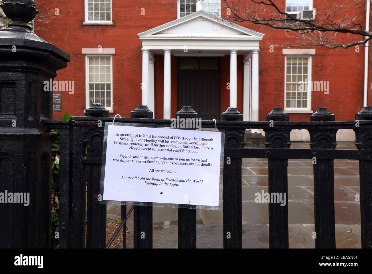 New York, NY, 25th March 2020. A sign on a gate outside the Fifteenth Street Quaker Meeting House in the Gramercy neighborhood of Manhattan inviting visitors to virtual worship during the coronavirus COVID-19 pandemic.   The meetinghouse has temporarily closed in accordance with Executive Order 202 issued by New York State Governor Andrew Cuomo placing restrictions on the operation of workplaces, businesses, and gathering spaces in New York State in order to control the spread of pandemic. Credit: Robert K. Chin. Stock Photo