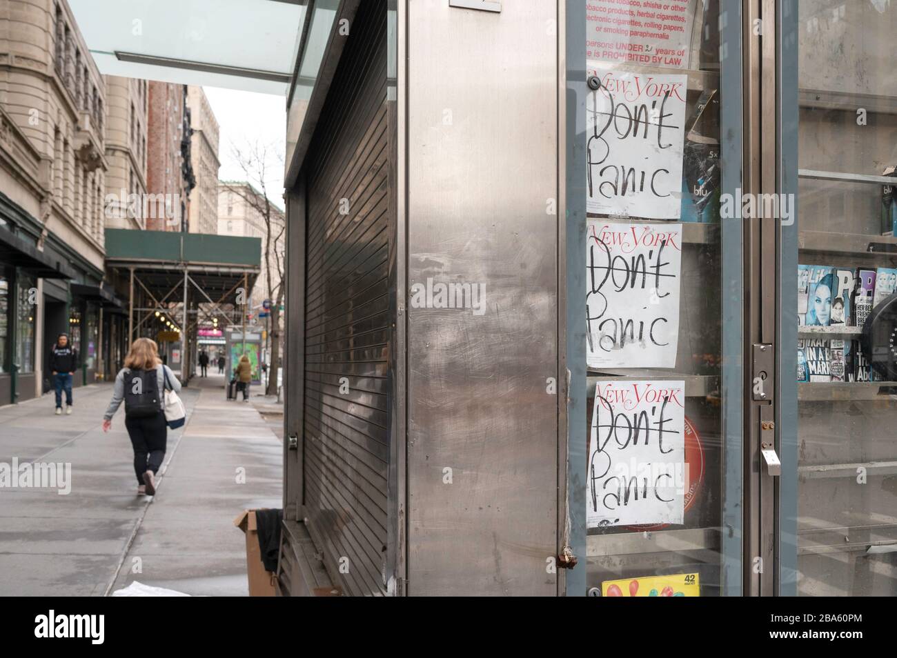NEW YORK, NY - MARCH 25, 2020. New York Magazine covers with the headline 'Don't Panic' are displayed in a shuttered newsstand on the Upper West Side of Manhattan during the Coronavirus outbreak. The World Health Organization declared coronavirus (COVID-19) a global pandemic on March 11th. Stock Photo