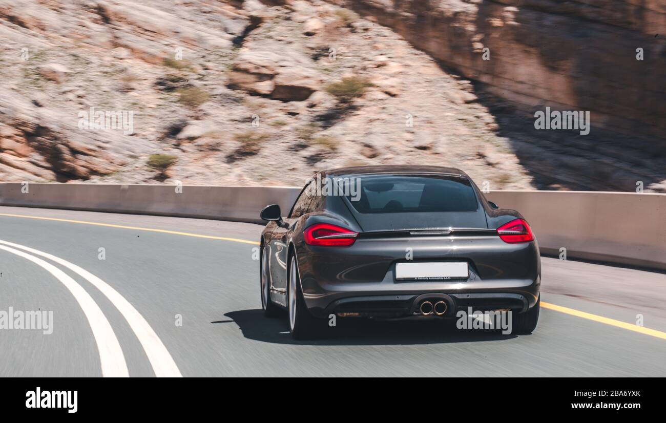 Driving a sport car in the mountain road, back view Stock Photo Alamy