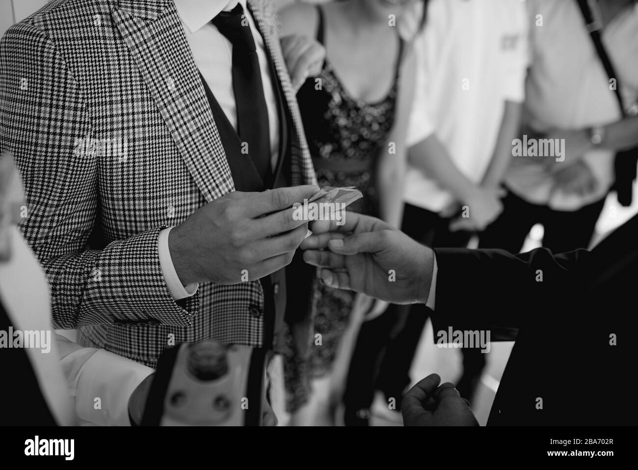 Rich man gives money Black and White Stock Photos & Images - Alamy