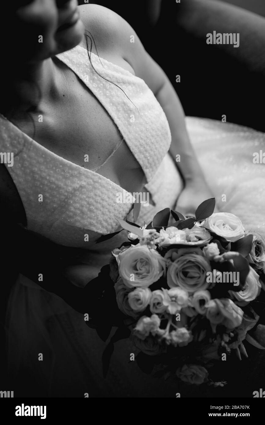 The bride in a beautiful wedding dress and her bridal bouquet of ...