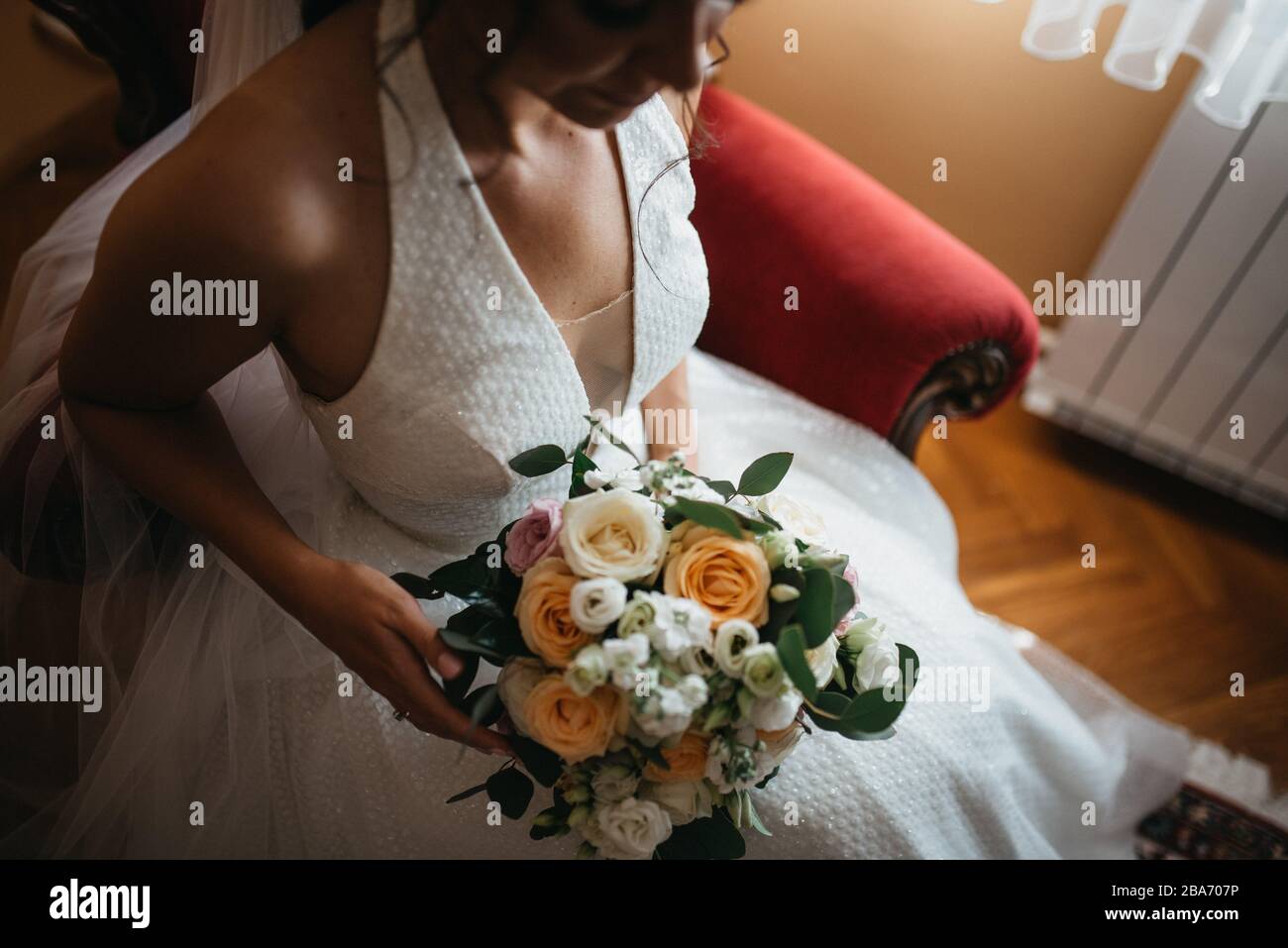 The bride in a beautiful wedding dress and her bridal bouquet of ...