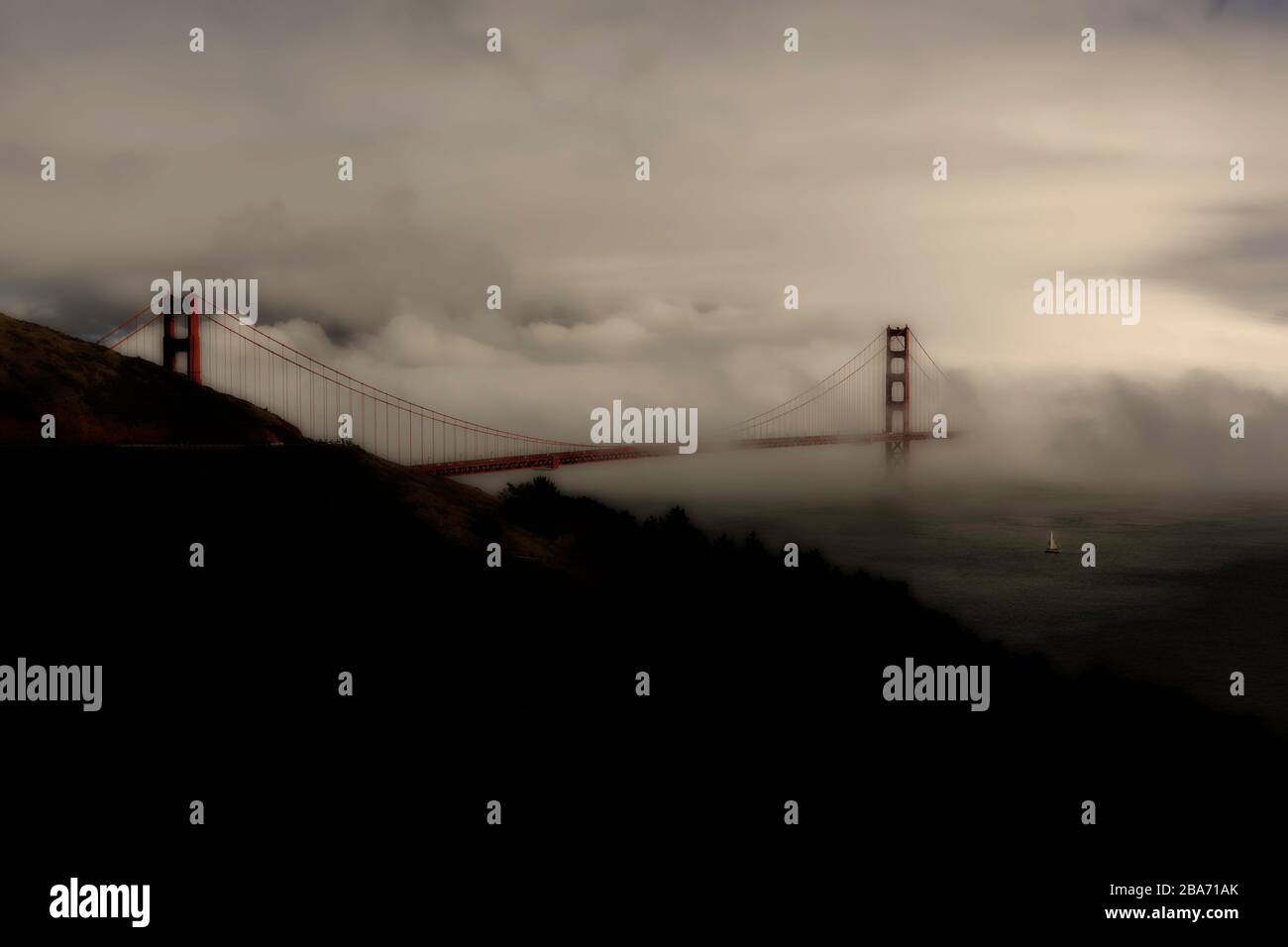 Golden view of Golden Gate Bridge in sun and fog from Marin Headlands, San Francisco, California, United States, North America, color Stock Photo