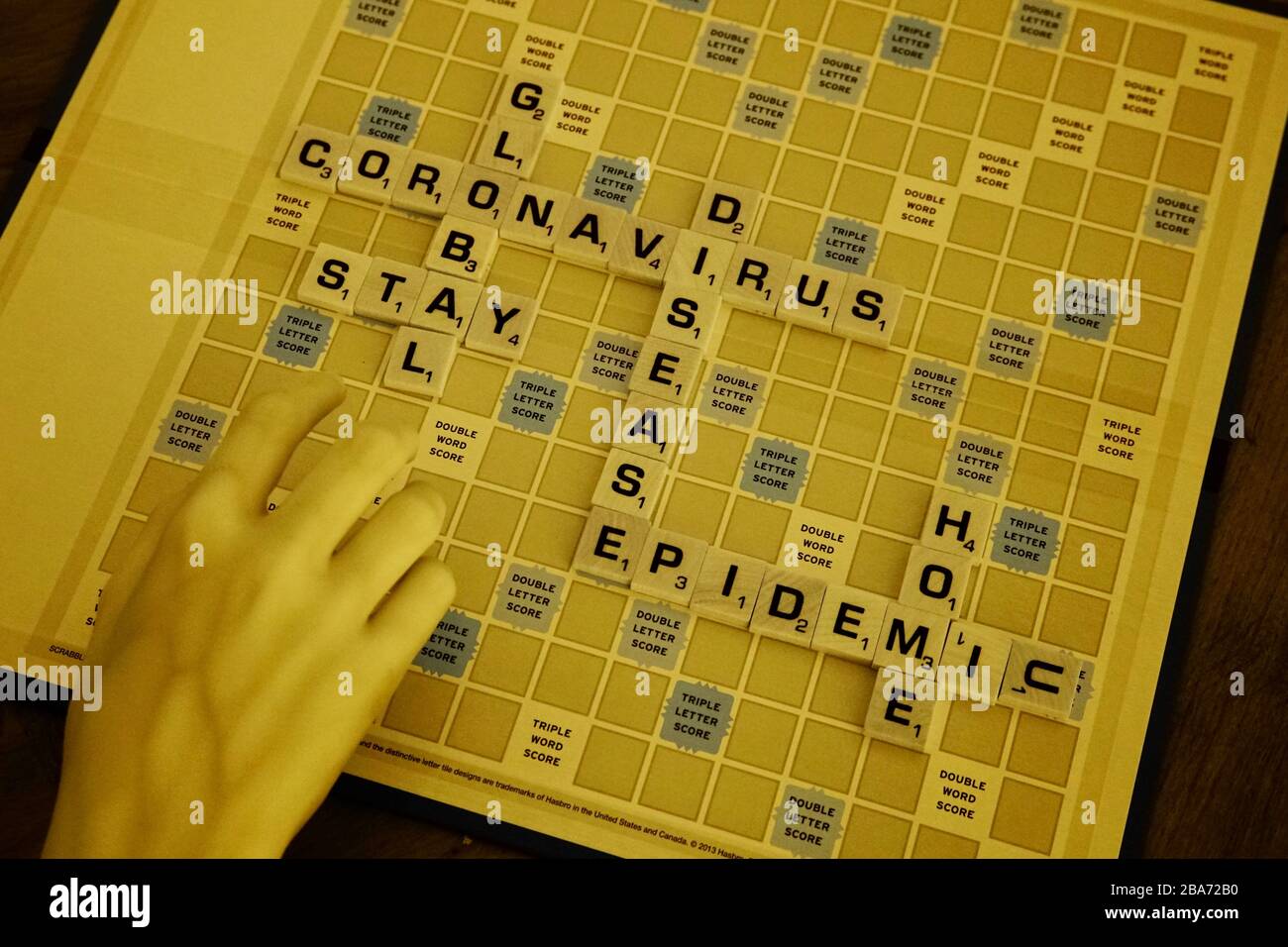 A monopoly board with words regarding the Coronavirus in infrared. Stock Photo