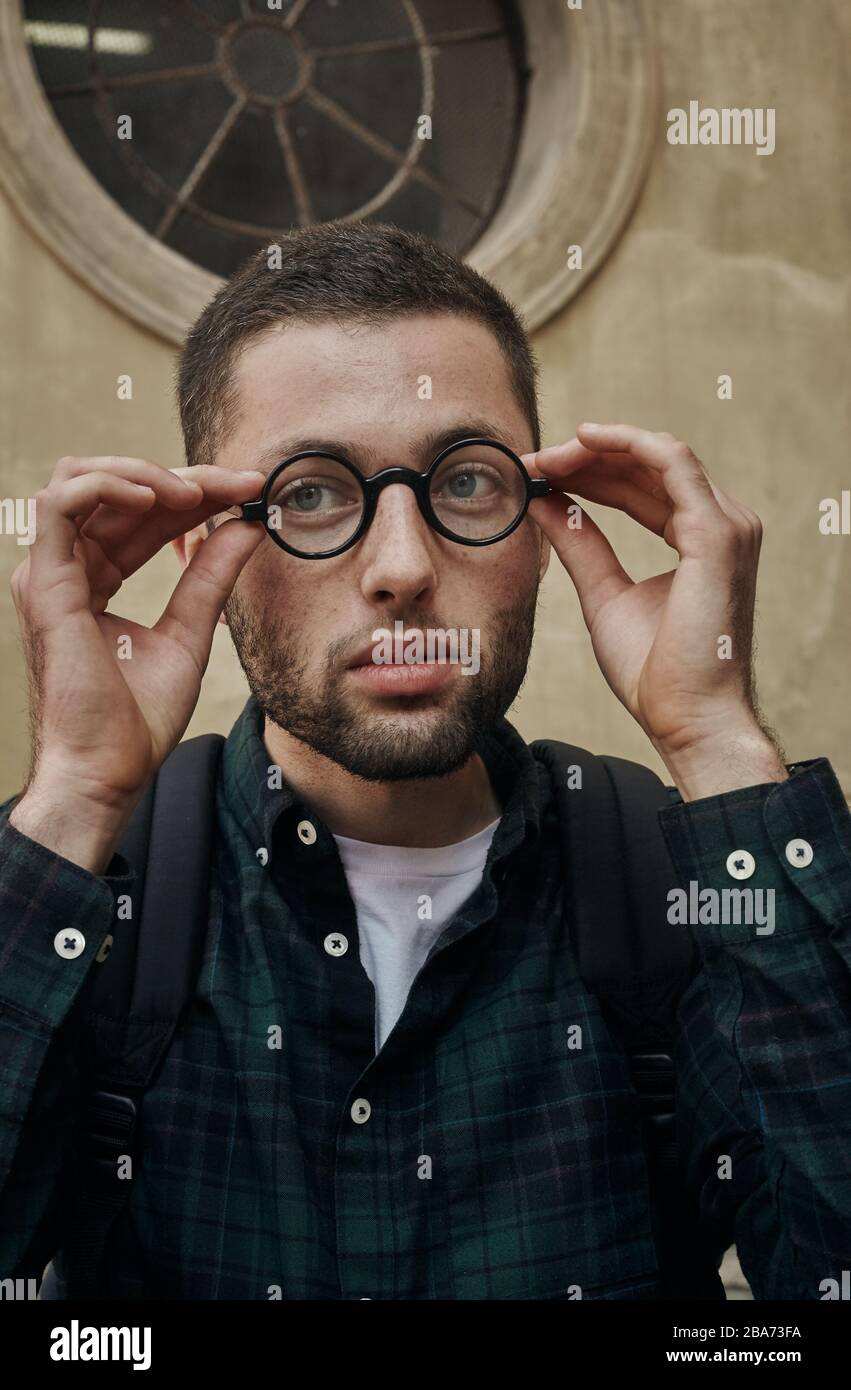 Portrait of beautiful young man in classic round glasses Stock Photo ...
