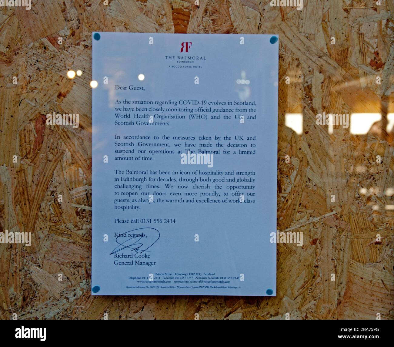 Princes Street, Edinburgh, Scotland, UK. 26th Mar 2020. On this third day of Lockdown in the UK, Princes Street awakes to discover that the Balmoral Hotel has boarded up the windows and closed, it has suspended business for a limited time. Pictured: notice in a boarded up window. Stock Photo