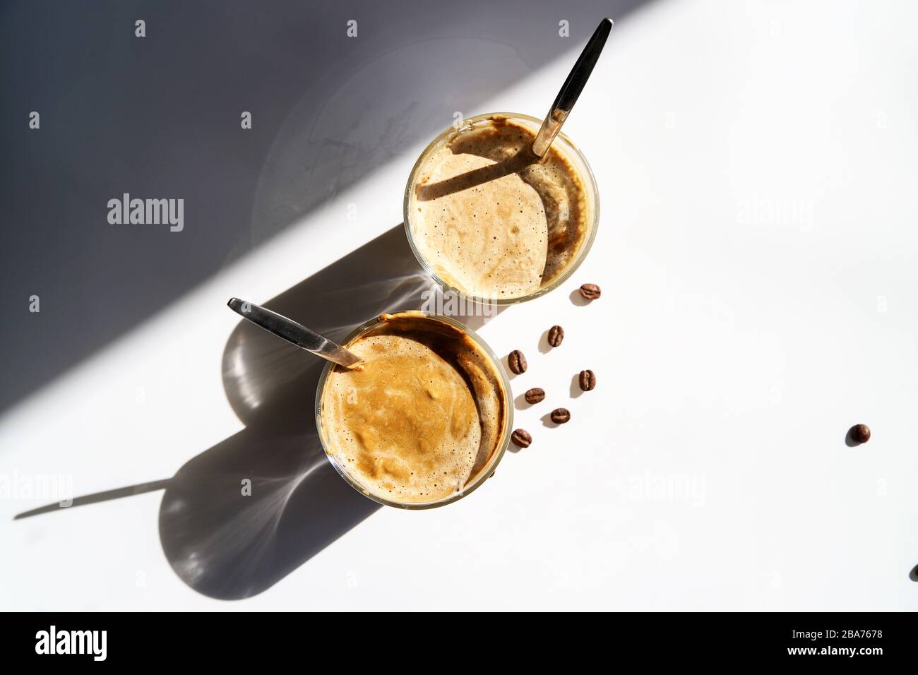 Cold coffee – latte, cappuccino or dalgona. Summer trendy drink with whipped milk, top view Stock Photo