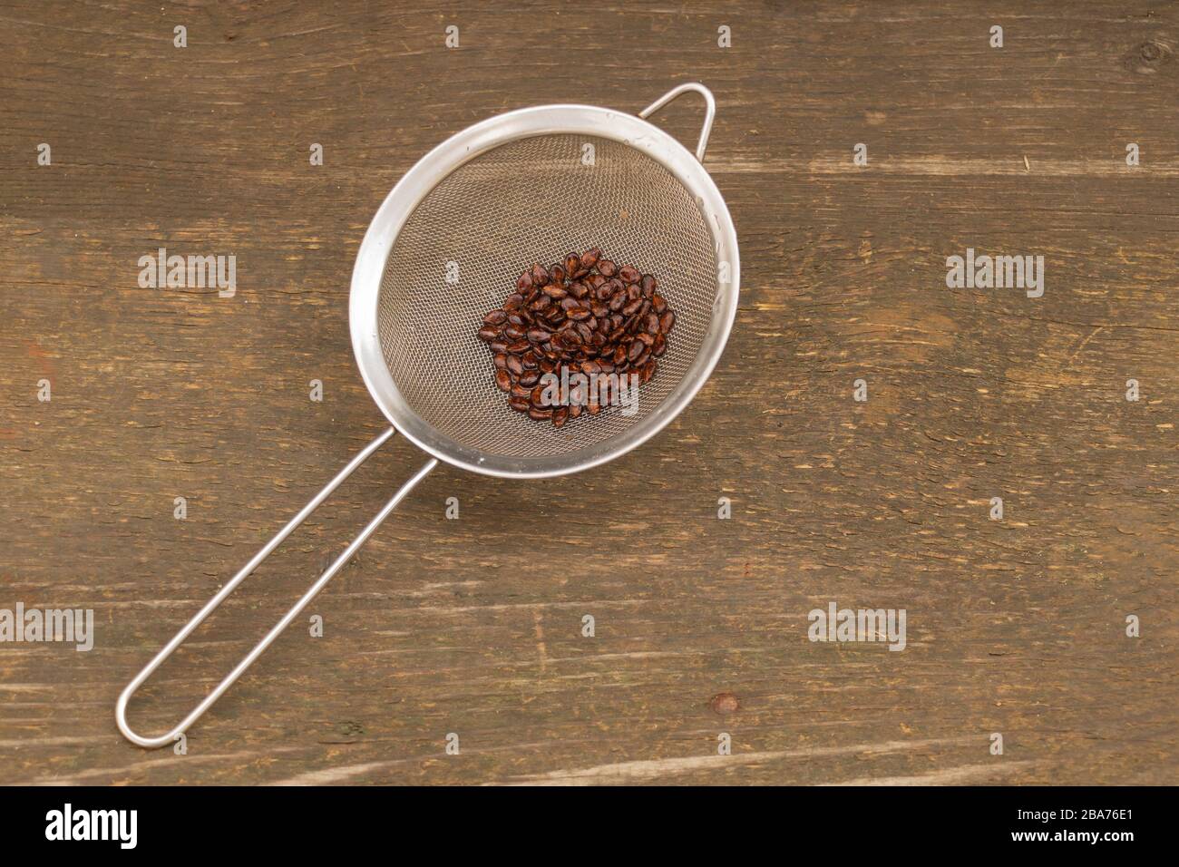 Watermelon seeds on wooden background, ready for sowing Stock Photo