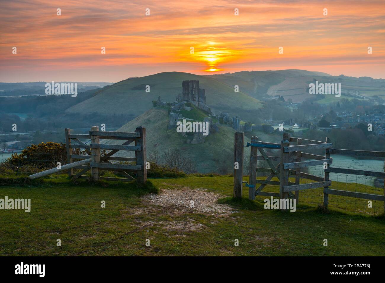 Corfe Castle, Dorset, UK.  26th March 2020.  UK Weather.   A light frost covers the ground at sunrise at Corfe Castle in Dorset after a night of freezing temperatures.  Picture Credit: Graham Hunt/Alamy Live News Stock Photo