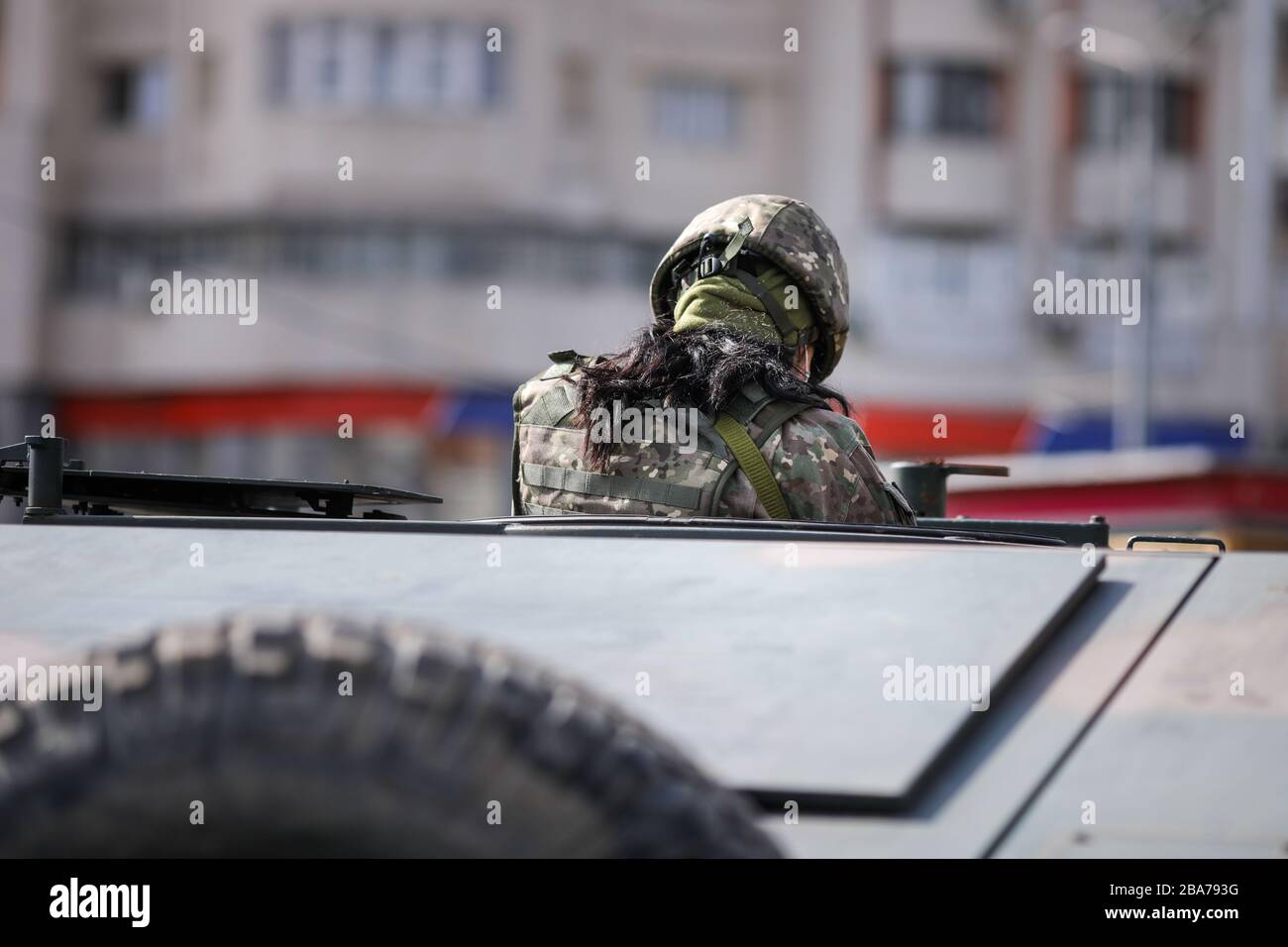 Bucharest, Romania - March 25, 2020: Romanian female soldiers in an armored vehicle. Stock Photo