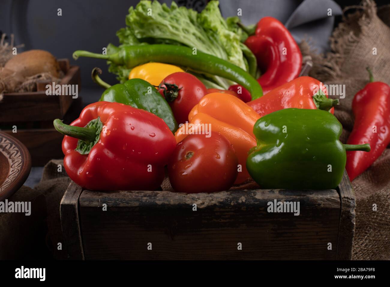 Colored bell peppers in a rustic container Stock Photo Alamy