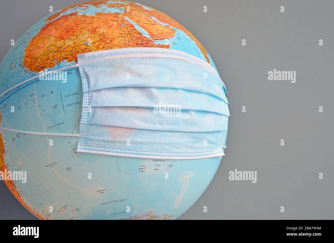 Image of earth globe with surgical mask Stock Photo