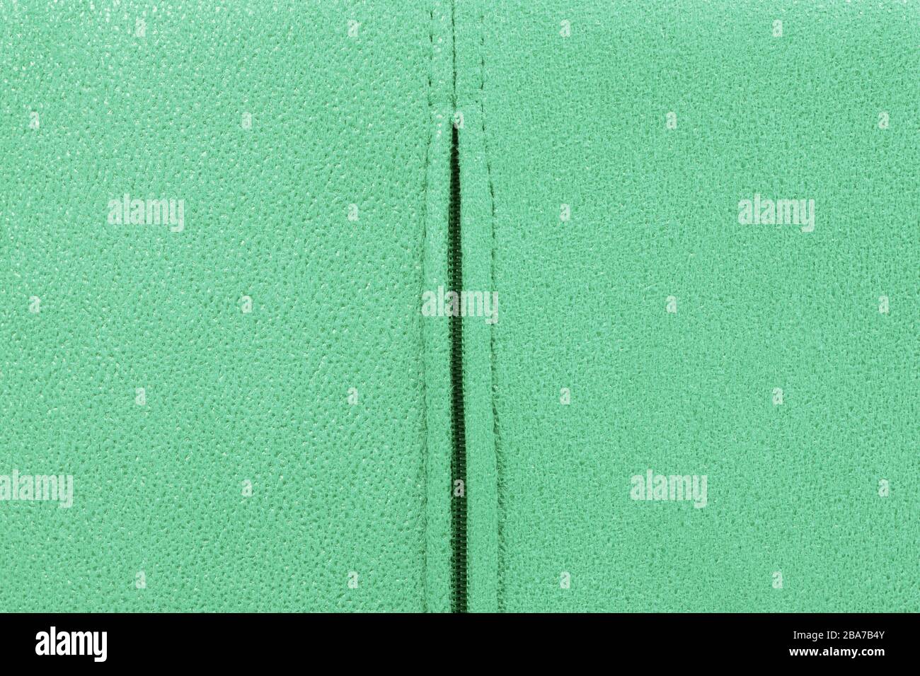 Background from green suede close up, zipper in the middle, full frame Stock Photo